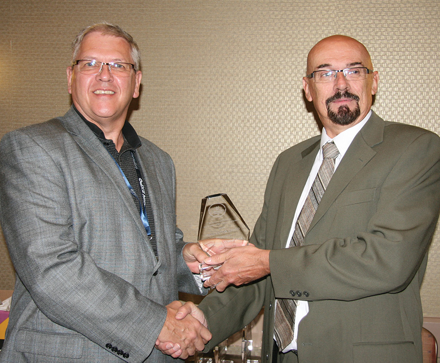 Stephen Woodland receiving his presidential award from RCNA
						President Bret Evans