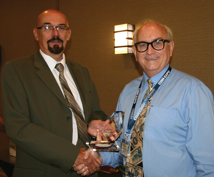 Daniel Gosling receiving his presidential award from RCNA
						President Bret Evans