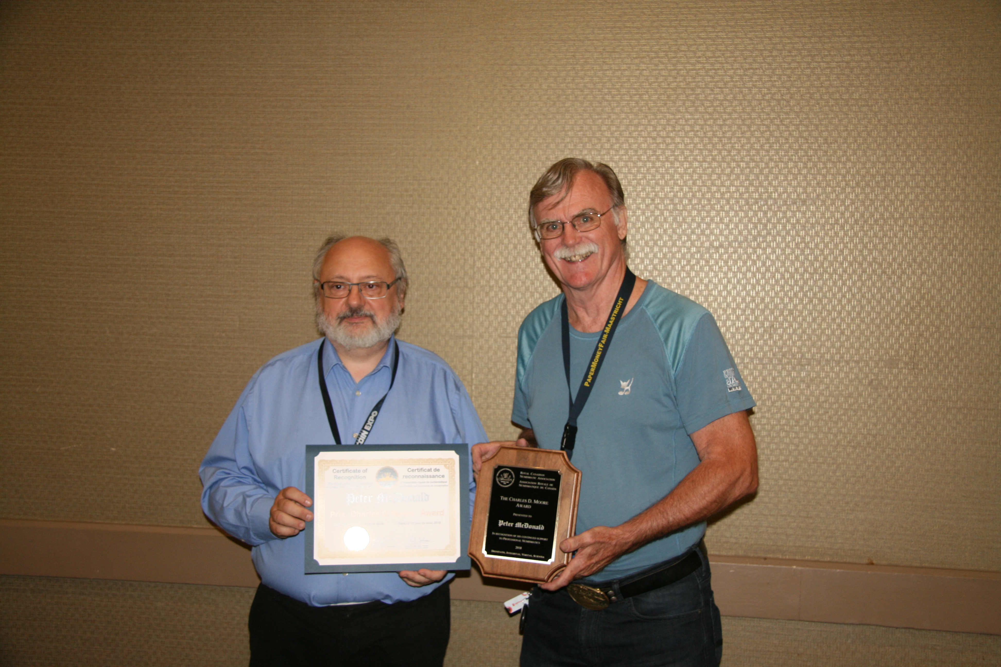 <p><strong>Peter McDonald</strong> (right) receiving the Charles D. Moore Award from <strong>Henry Nienhuis </strong>(left).<br> <small>Dan Gosling photo</small></p>