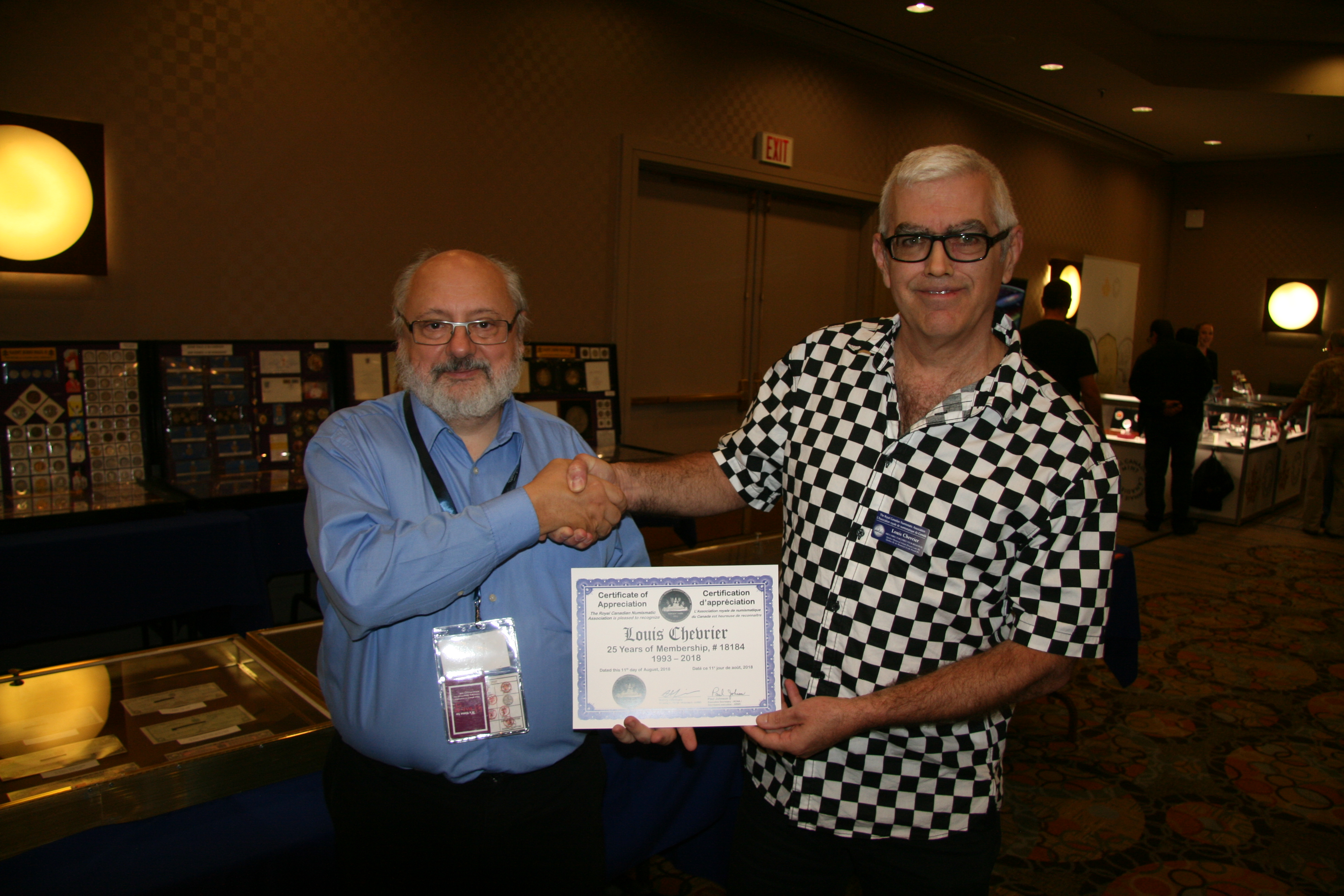 <p><strong>Louis Chevrier</strong> (right) receiving his 25 years of membership recognition award from <strong>Henry Nienhuis</strong> (left) <small>Dan Gosling photo</small>.</p>