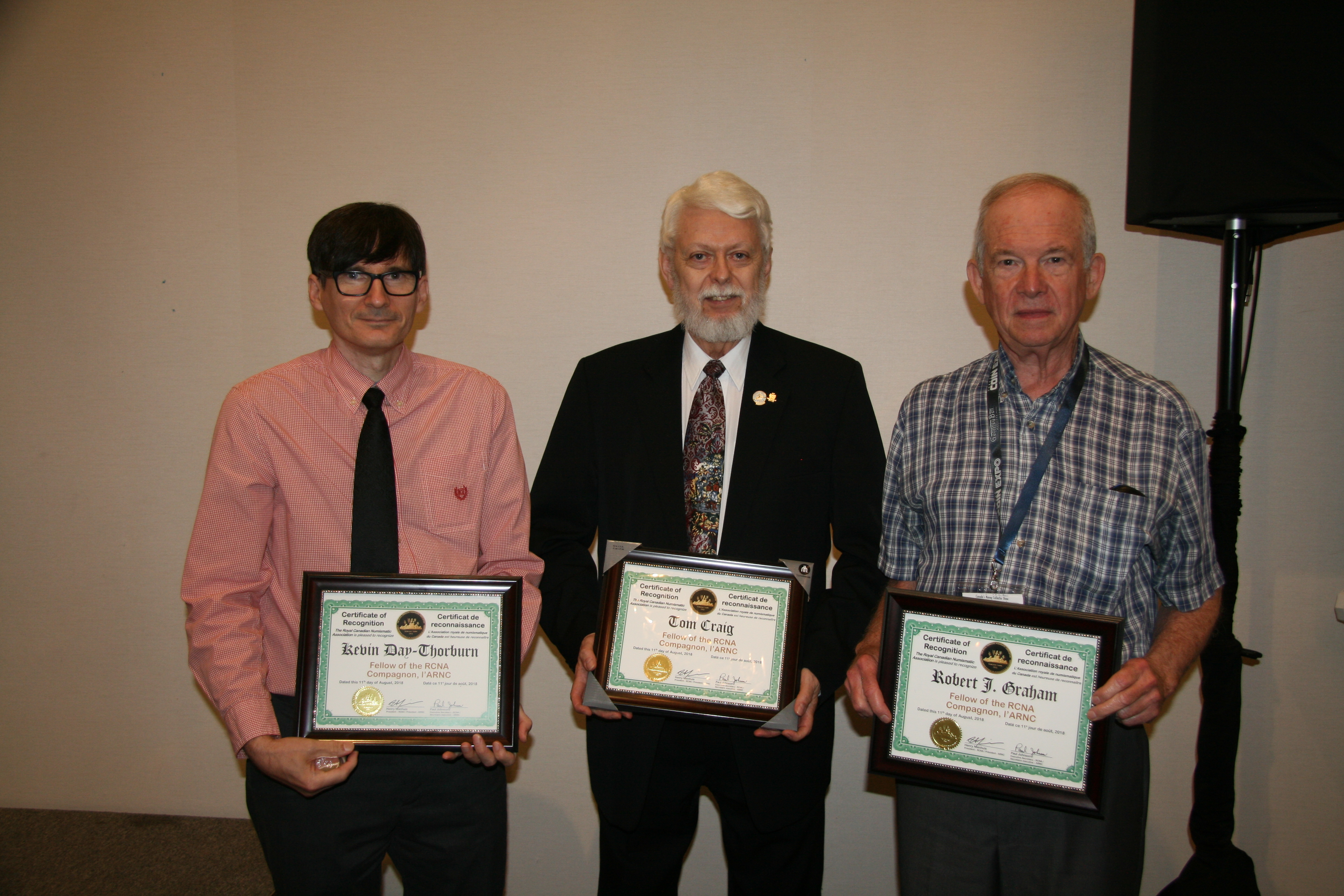 <p><strong>Kevin Day-Thorburn</strong> (left), Paul Petch, accepting for <strong>Tom Craig</strong> (center) and <strong>Bob Graham</strong> (right) receiving their Fellow Awards.<br /> <small>Dan Gosling photo</small></p>